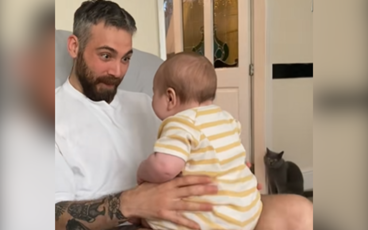 Dad captures the cute moment with the boy then see what is in the background